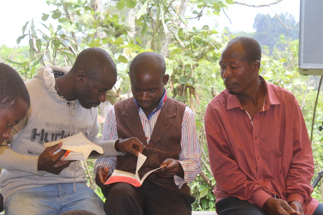 Batwa reading a  bible